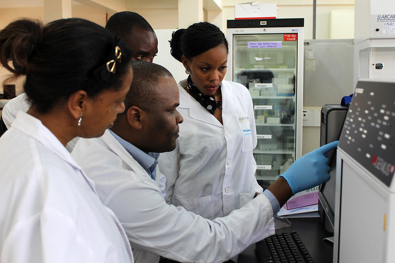 Scientists working with test tubes in a modern laboratory